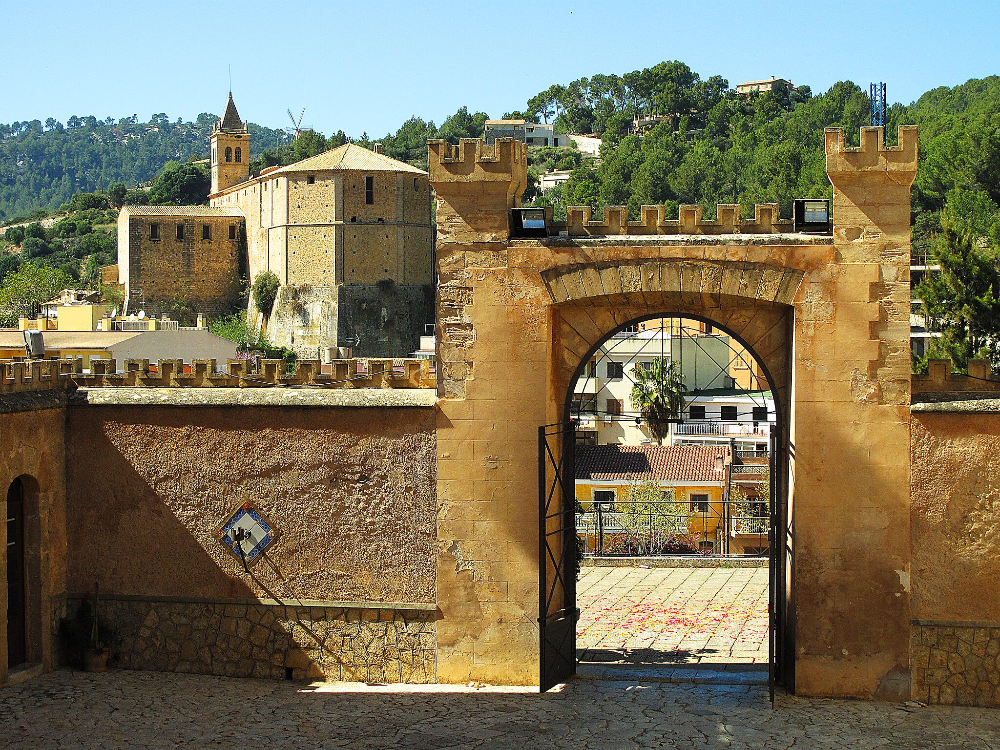 Castell_de_Son_Mas_(Andratx)_portal_d’entrada,_al_fons_l’església_de_Santa_Maria